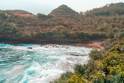 Scenic view of sea against mountains