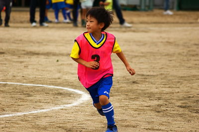 Boy running on field