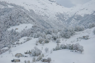 Snow covered landscape against mountain