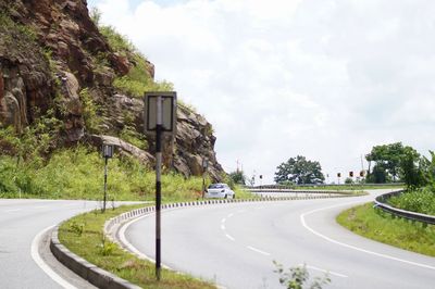Road by city against sky