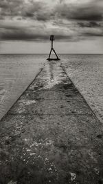 Pier over sea against sky