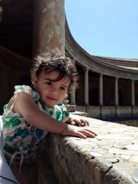 Baby girl standing at railing