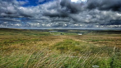 Scenic view of sea against storm clouds
