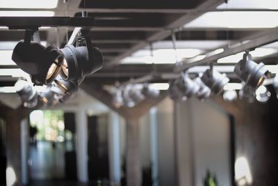 Low angle view of lighting equipment hanging in factory