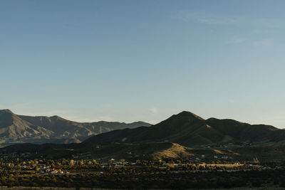 Scenic view of mountains against clear blue sky