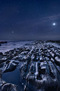 Aerial view of sea against clear sky at night