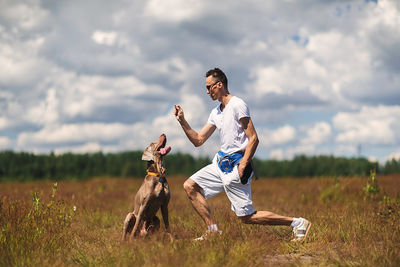 View of dog on field against sky