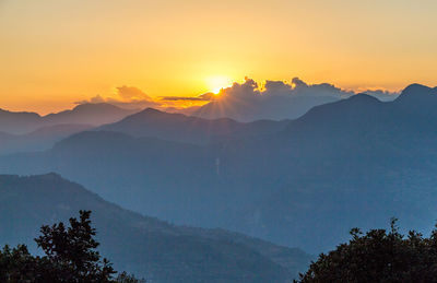 Scenic view of silhouette mountains against sky during sunset