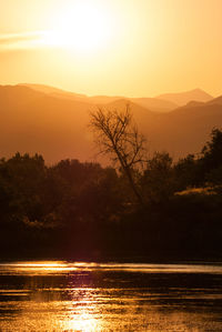 Scenic view of lake during sunset