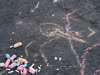 High angle view of chalks and drawing on road 