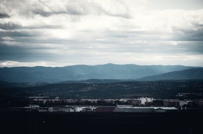 Cityscape against cloudy sky