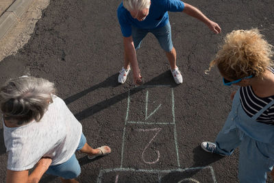 Rear view of people playing outdoors