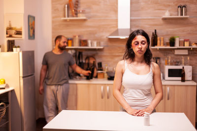 Portrait of young woman sitting at home