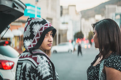 Rear view of woman standing on street