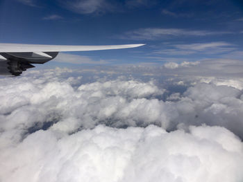 Aerial view of cloudscape over airplane wing