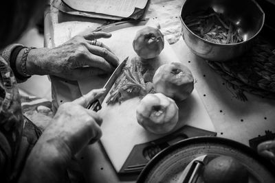 Close-up of woman chopping orange peel