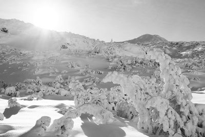 Scenic view of snow covered mountains against sky