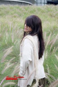 Woman standing on grass in park