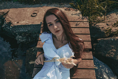 Portrait of a young woman sitting outdoors