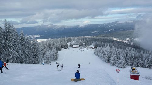 People skiing on mountain slope