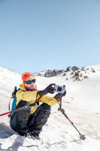 Close-up of a mountaineer taking a selfie in the snow