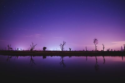 Scenic view of lake against star field at night