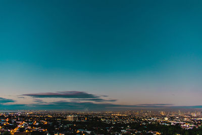 High angle view of illuminated cityscape against sky at night