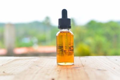 Essential oil in bottle on table