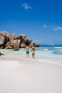 Scenic view of beach against blue sky