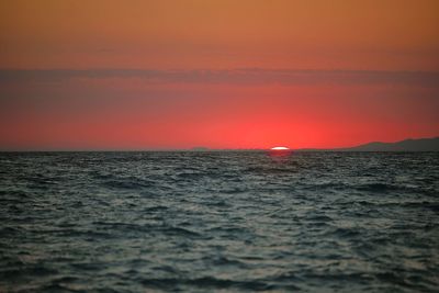 Scenic view of sea against romantic sky at sunset