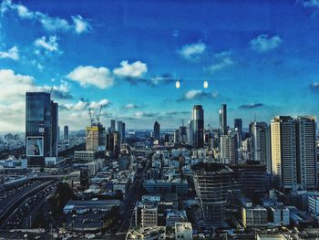 Cityscape against cloudy sky