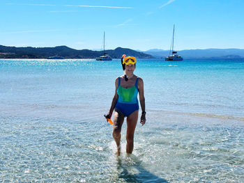 Full length of woman standing at beach