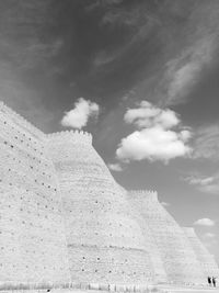 Low angle view of building against cloudy sky