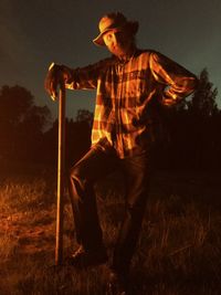 Man holding camera at night