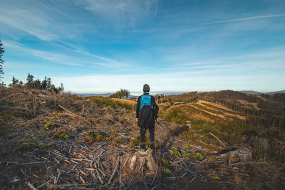 Traveller with a blue backpack on his back walks towards his unforgettable experiences in beskydy 