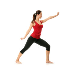 Full length of woman with arms raised against white background