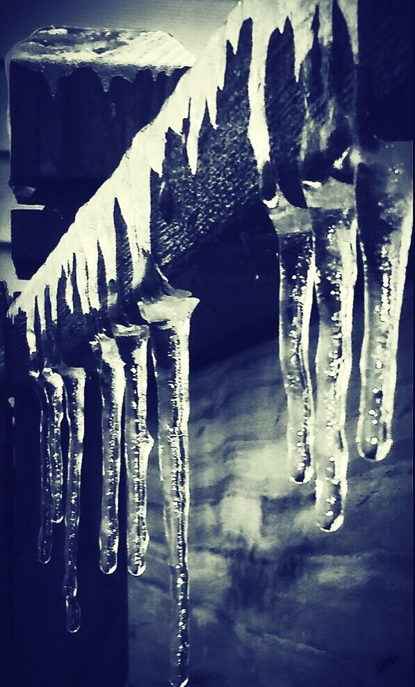 CLOSE-UP OF ICICLES HANGING IN ICE