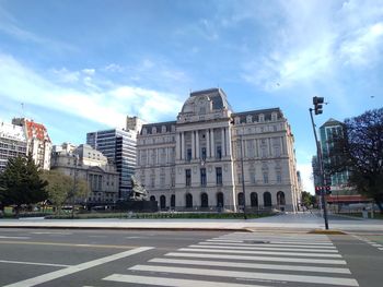 City street and buildings against sky