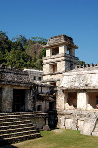 Low angle view of old ruins against clear blue sky