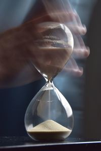 Blurred motion of hand holding hourglass