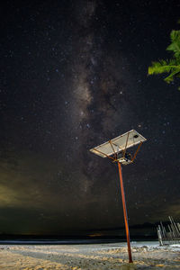 Low angle view of windmills against sky at night