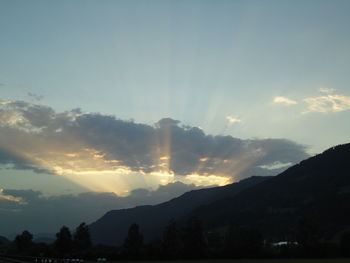 Scenic view of mountains against sky at sunset