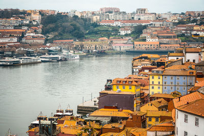 High angle view of river in old town against cloudy sky