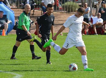 Group of people playing soccer on field