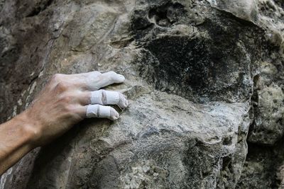 Midsection of person on rock