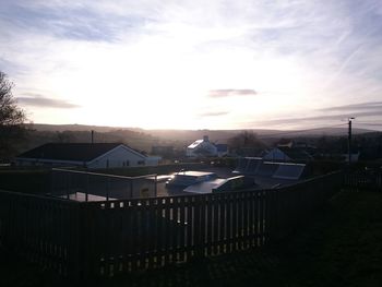 Houses against sky during sunset