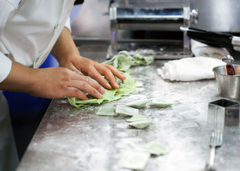 Midsection of man preparing food in kitchen