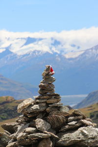 Stack of rocks on mountain against sky