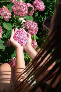 Close-up of woman holding bouquet of flowering plants