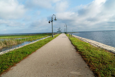 Road by street against sky